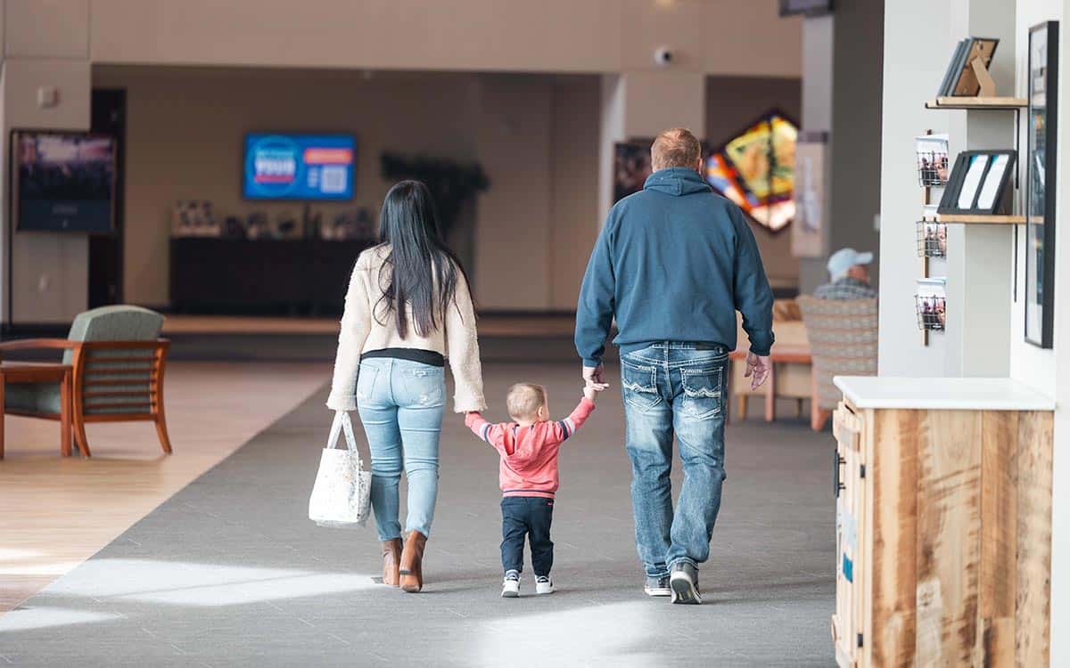 parenting kids cta image mother and father holding a toddler's hands walking away