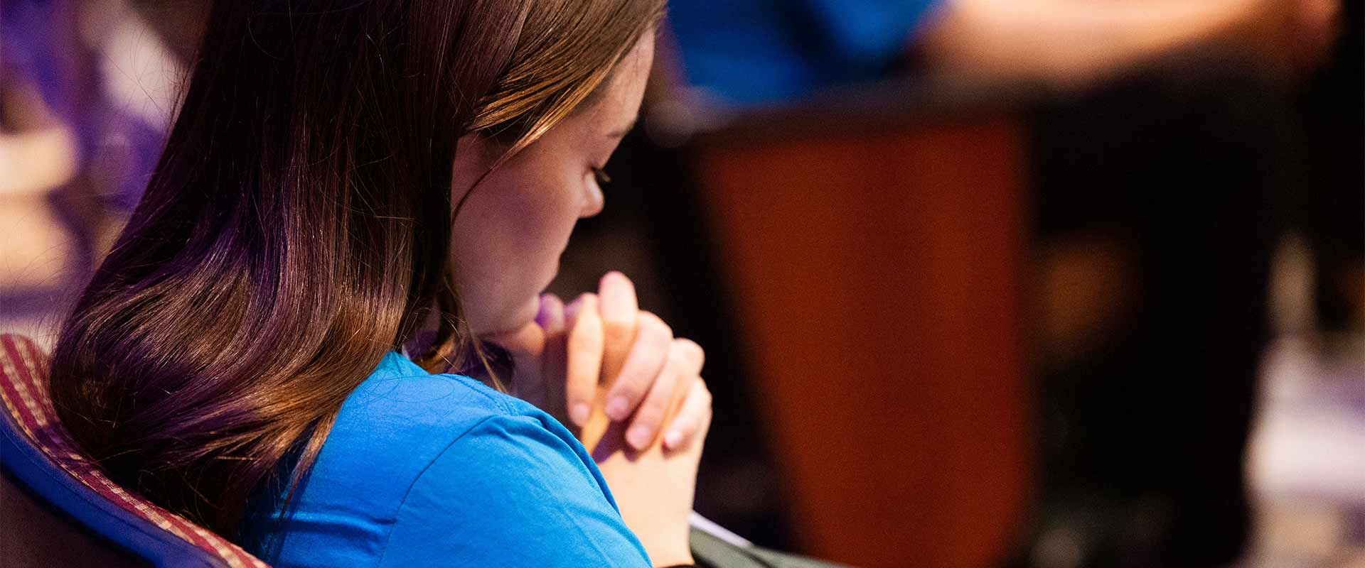 woman praying with hands together