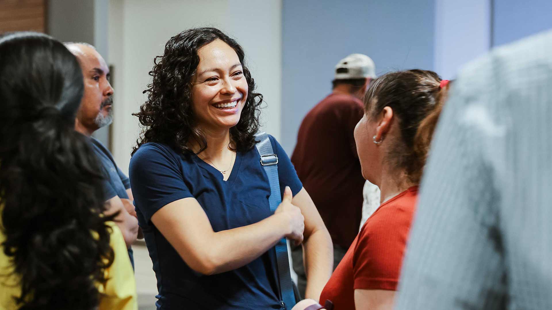 woman smiling at another woman in a group